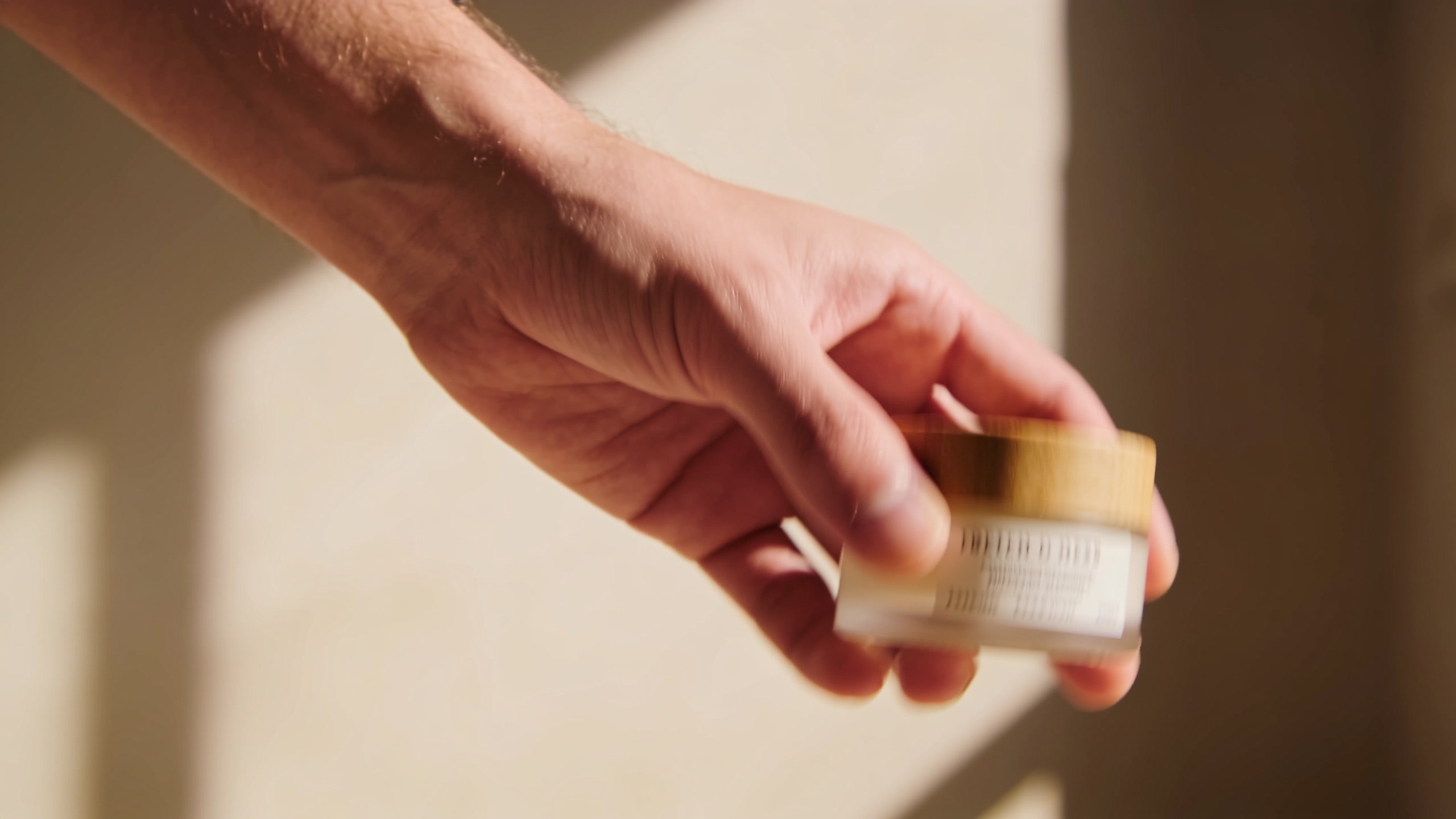 Product being revealed in a hand with warm lighting