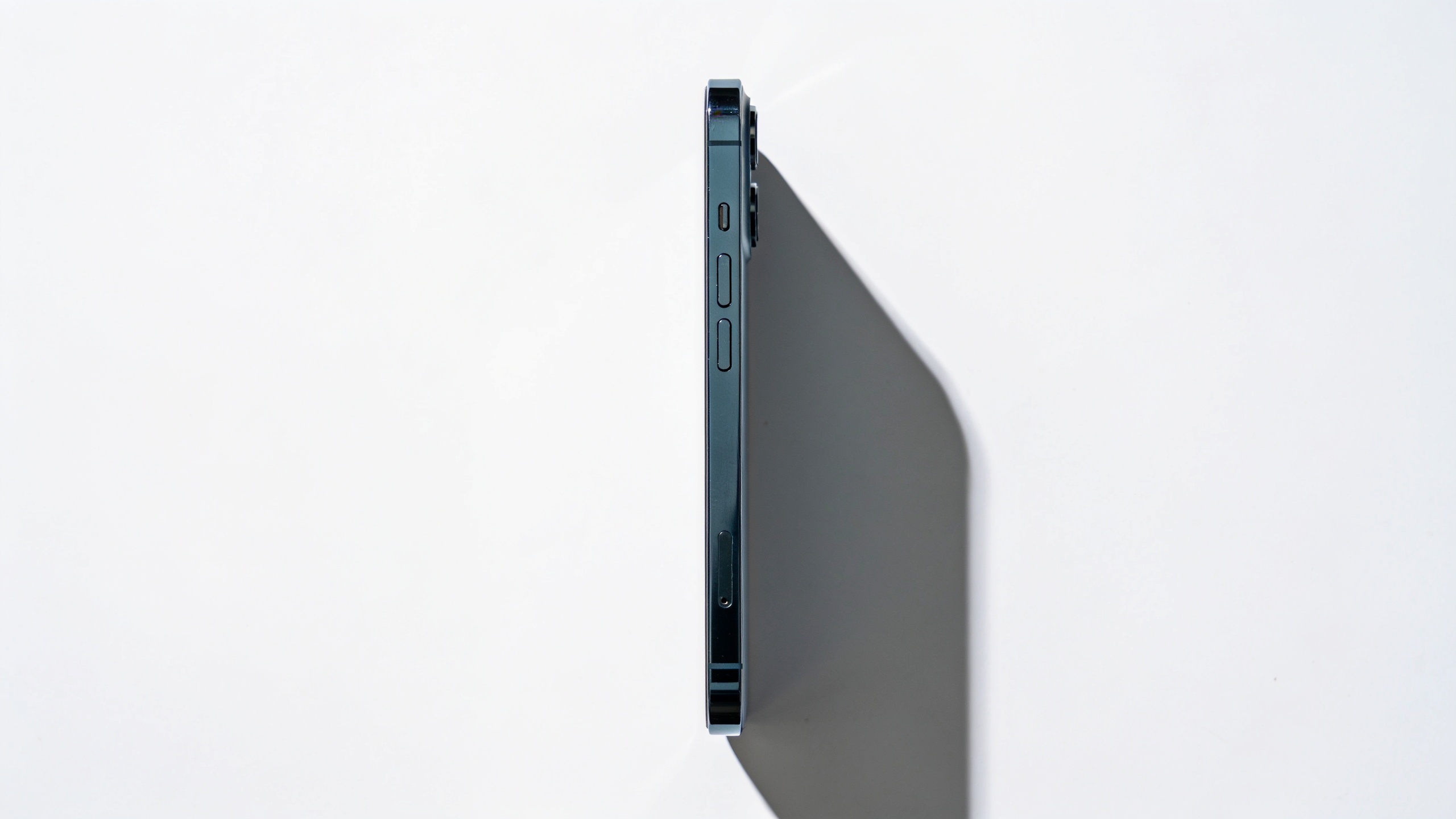 Overhead flat-lay of a tech gadget on white background, centered for vertical framing