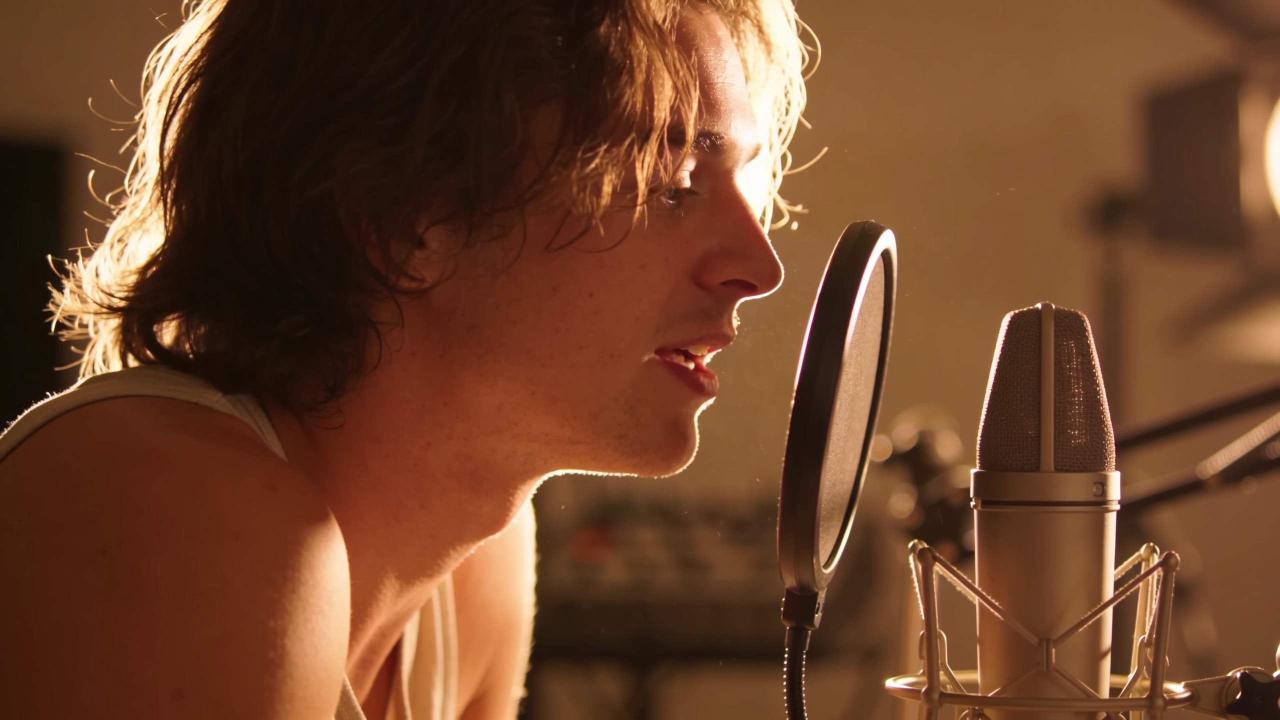 Creator recording a vocal tag into a microphone in studio
