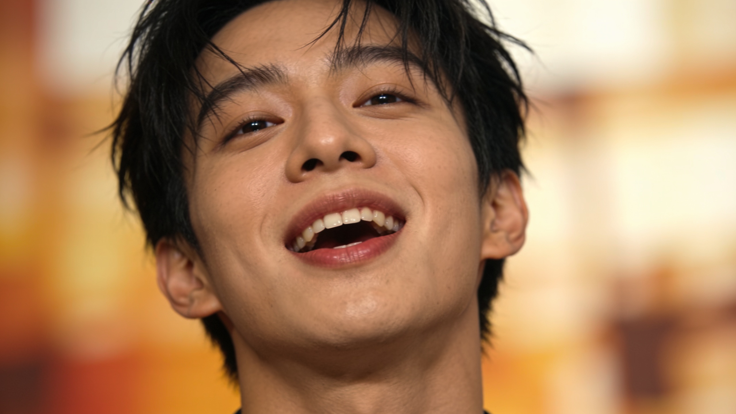 Close-up smiling person mid-lip-sync