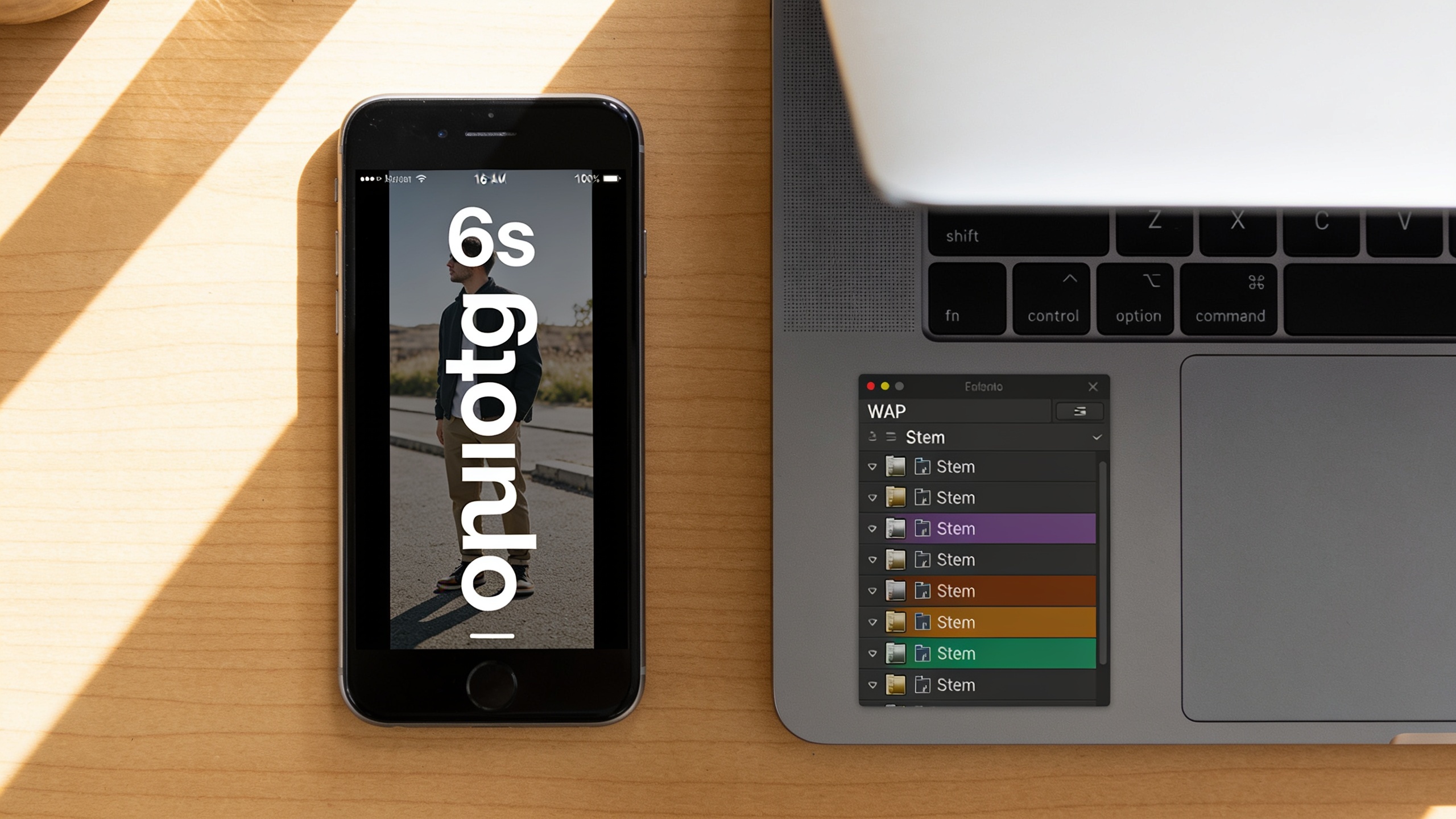 Phone playing vertical ad with laptop showing exported stems