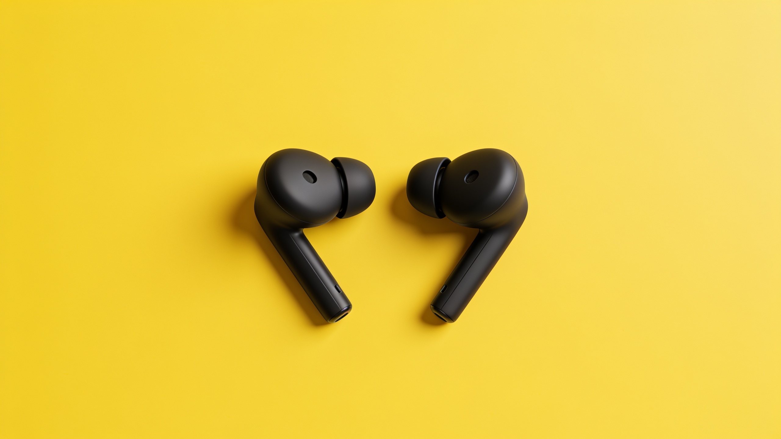 Black earbuds product hero on yellow background