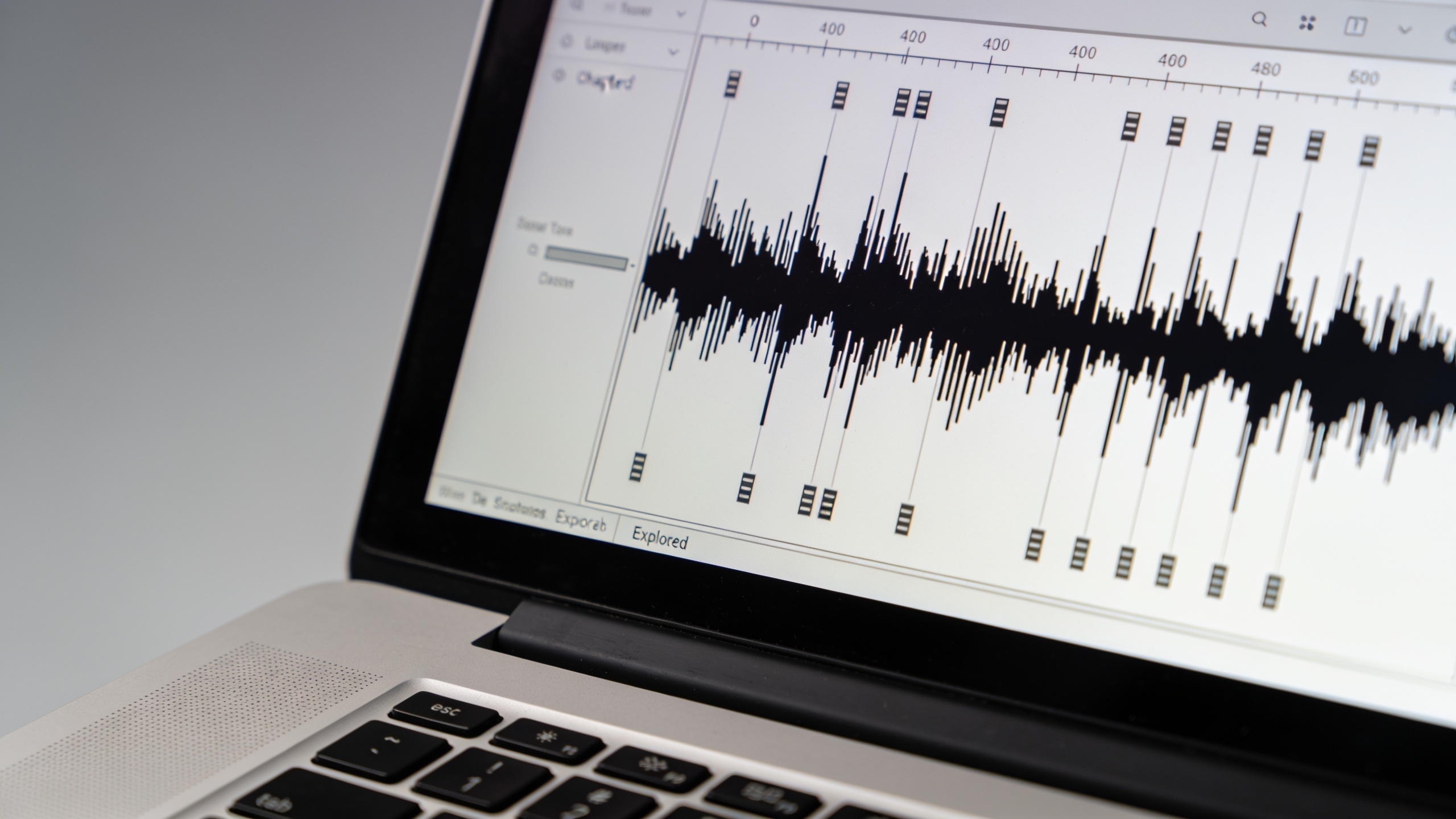 Laptop screen showing audio waveform and chapter markers